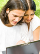 Young couple working with laptop, outdoor Young couple working with laptop, outdoor