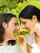 Young couple eating together outdoors Young couple eating together outdoors
