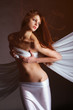 Beautifulwoman with a white cloth on a red background Beautifulwoman with a white cloth on a red background