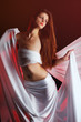 Beautifulwoman with a white cloth on a red background Beautifulwoman with a white cloth on a red background