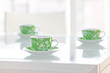 three cups of tea on a glass table