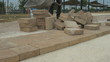 Worker cast brick tiles on the road