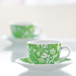 two cups of tea on a glass table