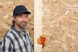 Carpenter holds a plank
