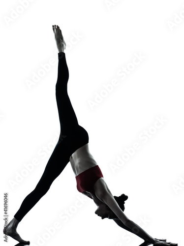 Photo: woman exercising yoga Adho Mukha Svanasana woman exercising yoga Adho Mukha Svanasana