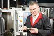 worker measuring detail with caliper worker measuring detail with caliper