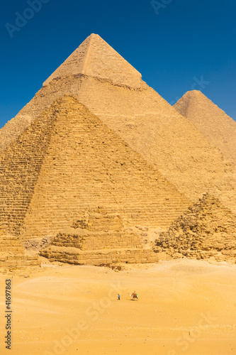Photo: Tourist Riding Camel Base Giza Pyramids Egypt Tourist Riding Camel Base Giza Pyramids Egypt