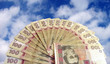 fan-shaped money over sky (hrivna)