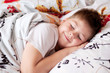The boy was asleep on a pillow with Chinese characters