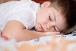 The boy was asleep on a pillow with Chinese characters
