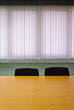 Meeting room with wooden table and black chairs