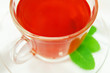 Hot fruit tea wint mint leaves on transparent plate