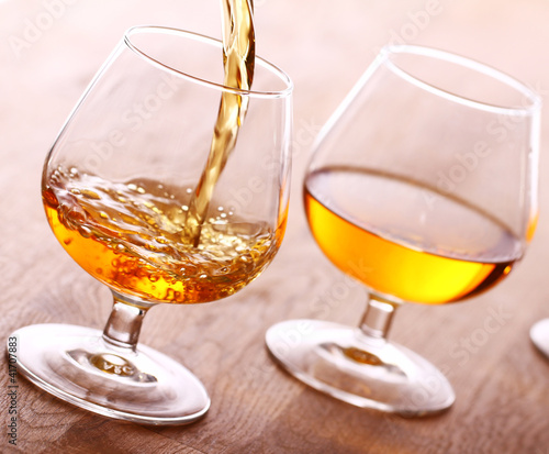 Foto: Pouring cognac into the glass Pouring cognac into the glass