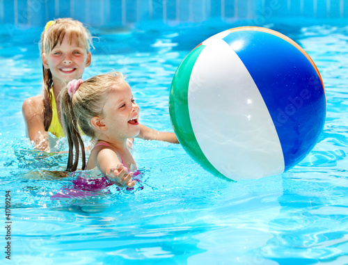 Photo: Children swimming in pool. Children swimming in pool.