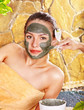 Young woman having clay body mask. Young woman having clay body mask.