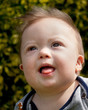 Baby boy with Down Syndrome gazing upward
