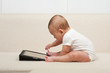 Foto: Baby with a small computer Baby with a small computer