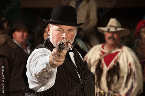 Photo: Old Western Smoking Man with Gun Old Western Smoking Man with Gun