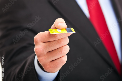 Photo: Businessman holding a credit card Businessman holding a credit card