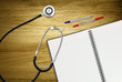 open work book and stethoscope