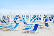 Beach umbrellas and blue deckchairs Beach umbrellas and blue deckchairs