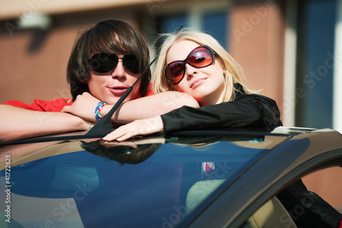 Photo: Young couple in a car. Young couple in a car.
