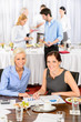 Two business women work during catering buffet