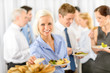 Smiling business woman during company lunch buffet