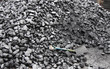 A Large Pile of Coal with a Shovel.