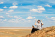 man with laptop praying to the God