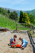 Two boy play outdoor with toys