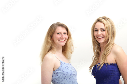 Photo: Two smiling women posing on white background Two smiling women posing on white background