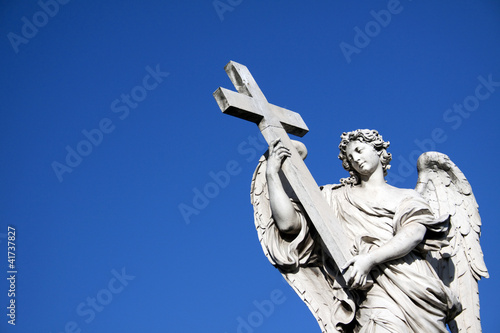 Photo: Angel with crucifix near Castel St. Angelo in Rome Angel with crucifix near Castel St. Angelo in Rome