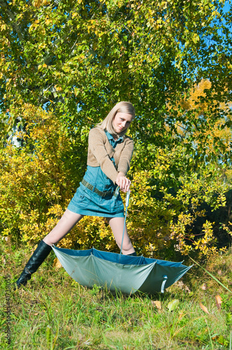 Photo: young woman posing near a tree young woman posing near a tree
