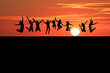 silhouette of teenagers jumping on beach in sunset silhouette of teenagers jumping on beach in sunset
