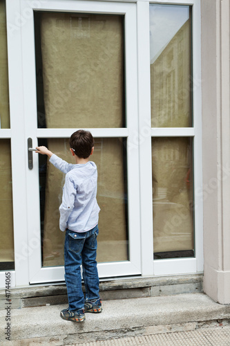 Photo: Boy in front of the door Boy in front of the door