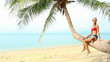 Sexy blond woman in red bikini resting on palm tree at seaside