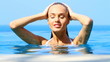 Sensual beauty relaxing in tropical swimming pool with a view