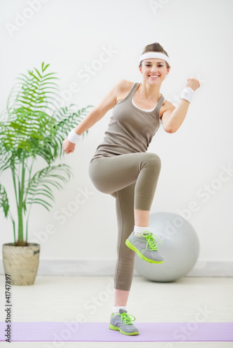 Photo: Happy fitness woman making gymnastics Happy fitness woman making gymnastics