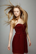 Fashion model posing with hair fluttering in the wind
