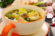 Fish soup with vegetables in bowl close up.