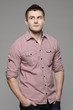 Pensive man standing with his hands in pockets looking up