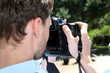Closeup on man using photo camera Closeup on man using photo camera