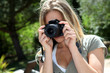 Closeup on woman using photo camera Closeup on woman using photo camera
