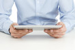 Close up of man reading at digital tablet