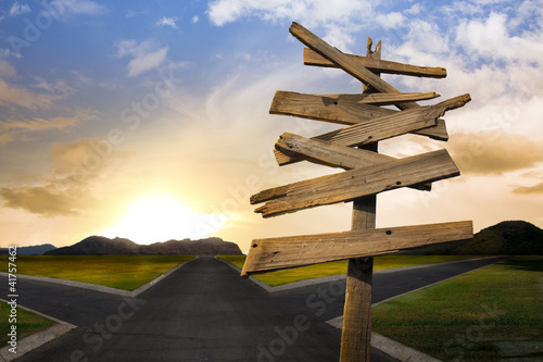 Photo: crossroads with confusing directional arrow sign crossroads with confusing directional arrow sign