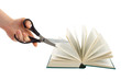 Hand with scissors cutting book Hand with scissors cutting book