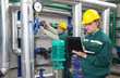 Foto: Industrial workers in a factory, teamwork Industrial workers in a factory, teamwork