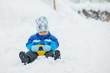 The boy goes for a drive on an snow slope. The boy goes for a drive on an snow slope.