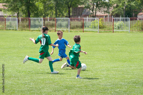 Photo: children playing soccer children playing soccer